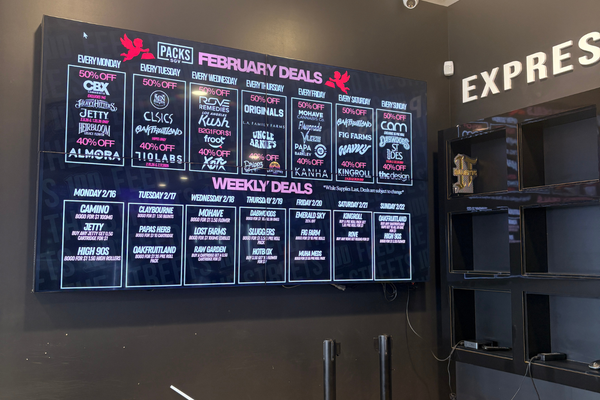 Digital board showing weekly cannabis deals inside dispensary