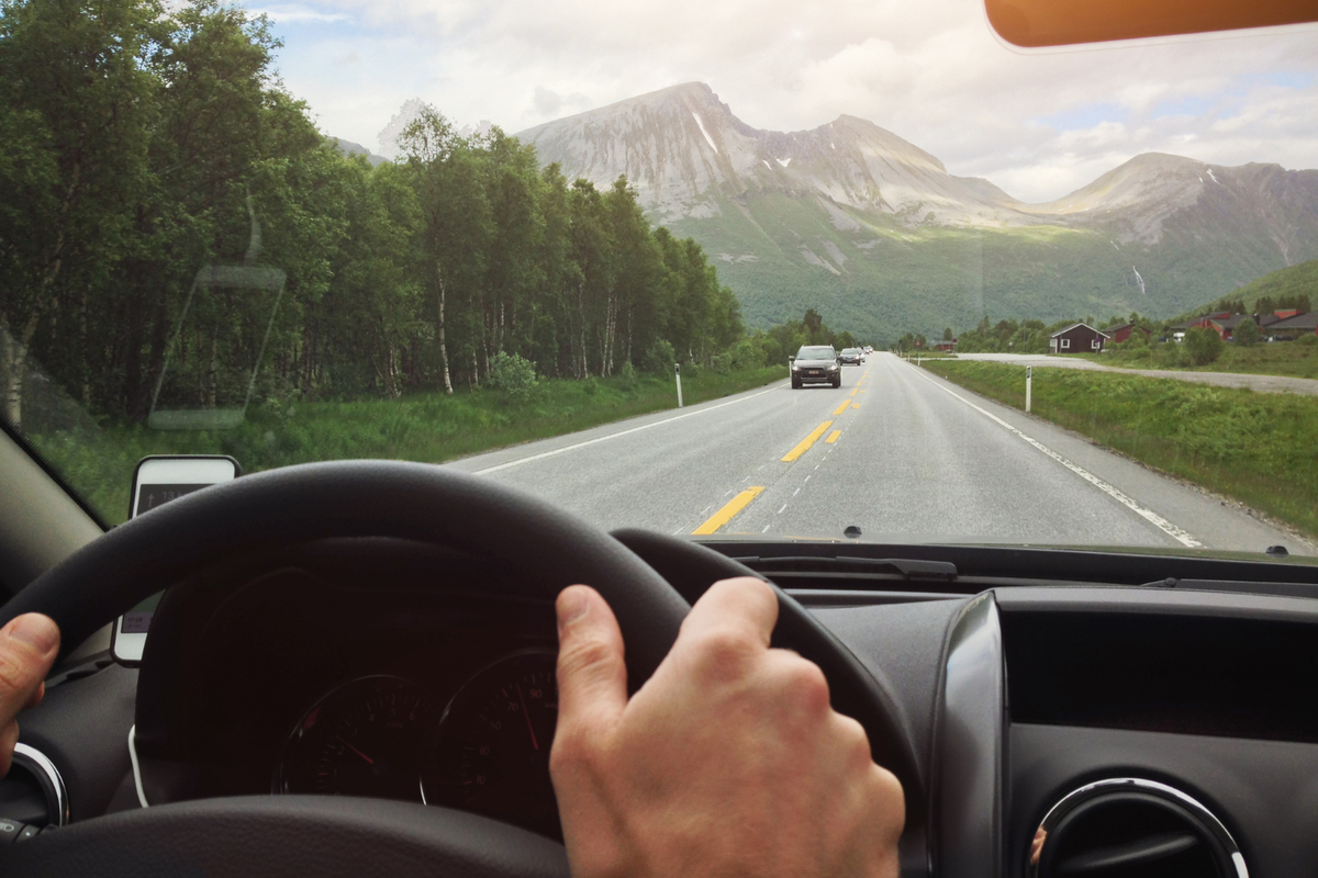 Driver’s view of a road while heading home after visiting a cannabis store nearby, illustrating safe and legal driving practices to avoid open container violations.