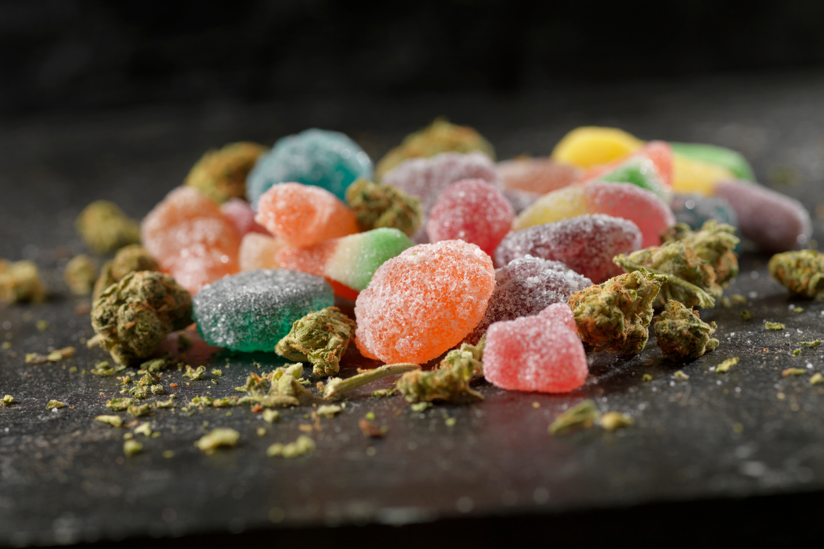 Cannabis gummies with weed buds around it.