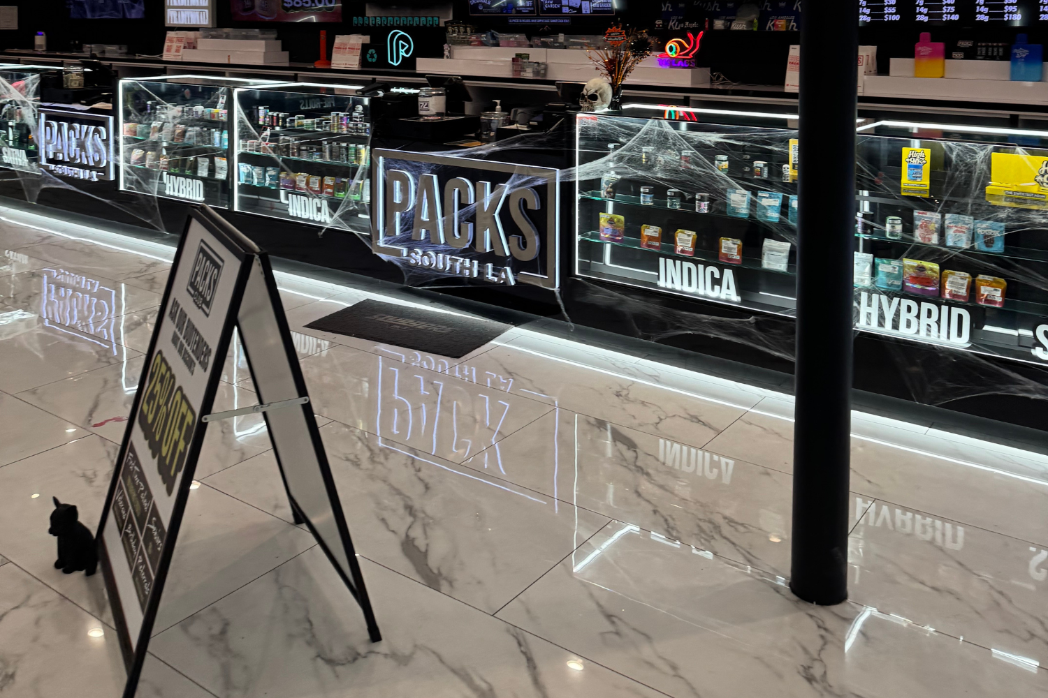 ACKS Club cannabis display cases with flower, vape, edible, hybrid, indica, and sativa sections for shoppers looking for first time dispensary deals near me