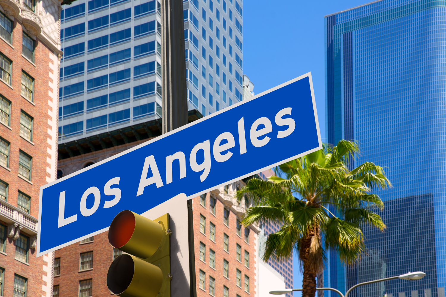 Los Angeles street sign with downtown skyline, representing a typical location where tourists and locals prepare what to bring before visiting a Los Angeles weed dispensary.