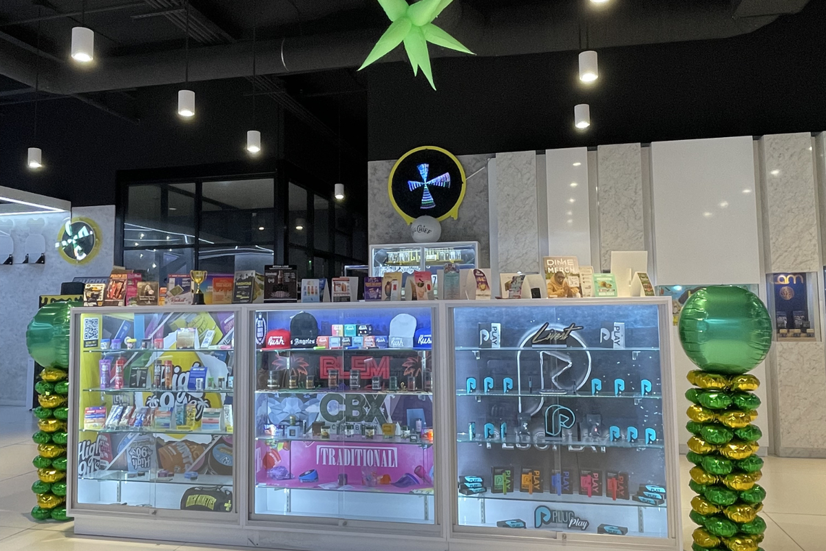 Packs Club counter with cannabis displays, digital discount boards, and concentrate deals near me.