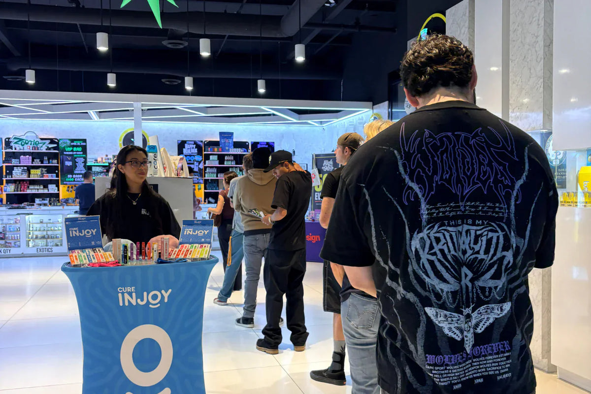 Customers inside Packs Club dispensary exploring cannabis products and dispensary coupons for weed specials and daily deals.